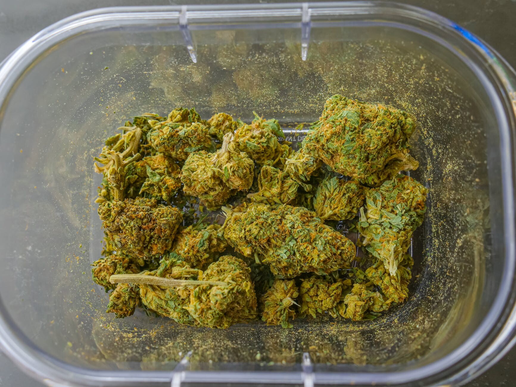 photo of cannabis flowers on glass container